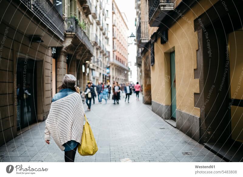 Spain, Barcelona, young woman walking in an alley tourist tourists lane Laneway Incidental people People In The Background background person
