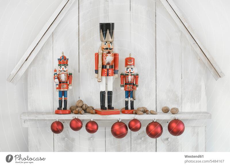 Christmas decoration with three nutcrackers, Christmas baubles and nuts modern contemporary simplicity simple still life still-lifes still lifes Hazelnut
