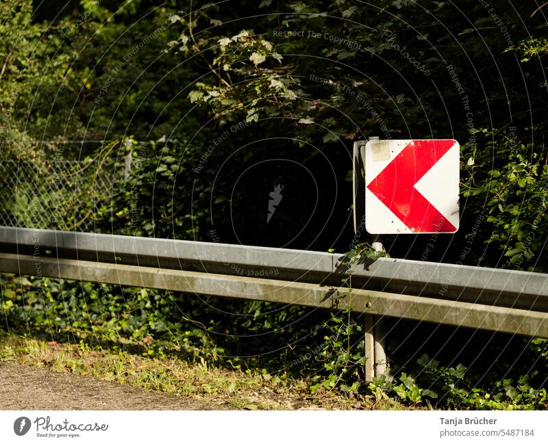 Warning sign with red arrow - Attention curve to the left! esteem dangerous curve sharp bend Left Dangerous Crash barrier Curve Red arrows on white background