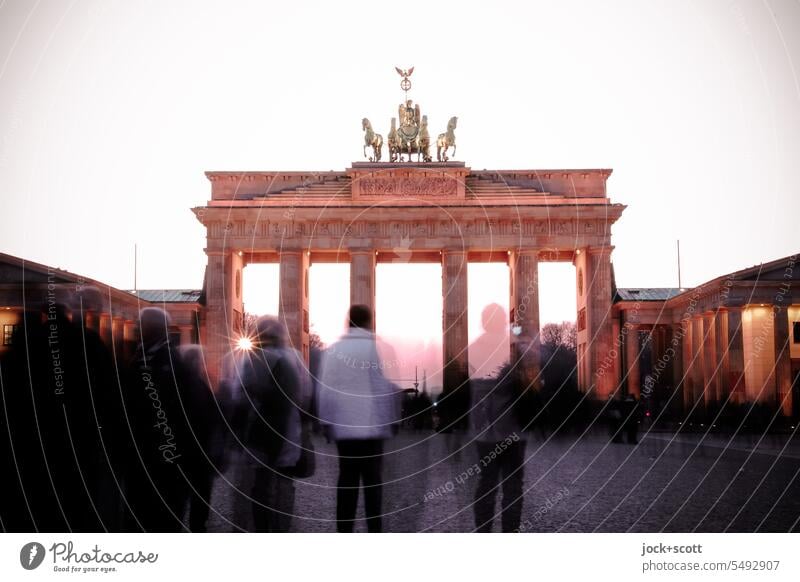 Tourists visit the Brandenburg Gate in the last light of day Berlin Historic Tourist Attraction Landmark Pariser Platz Germany Sightseeing Famousness Tourism