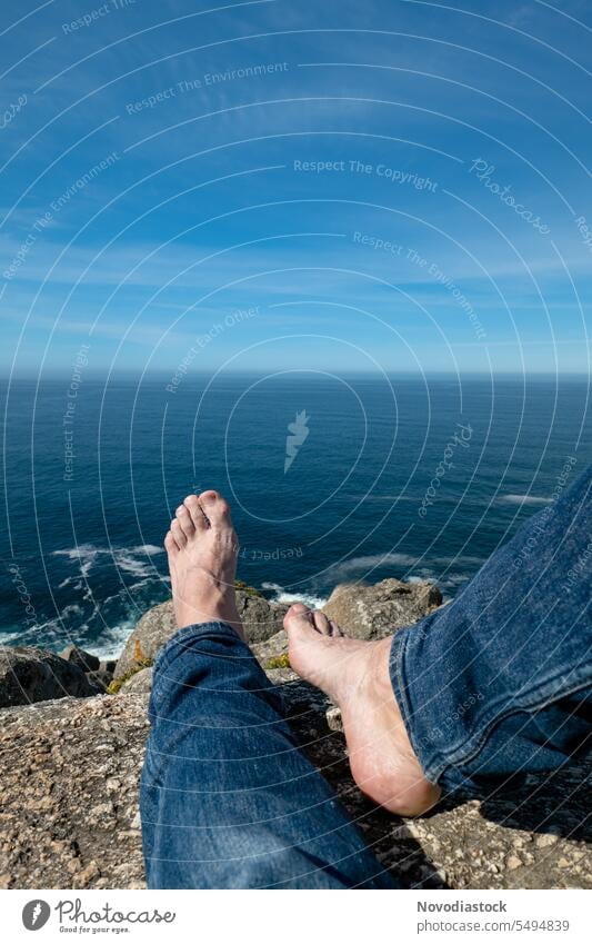 Feet of a man on a rock by the sea Barefoot Man person Body No faces Ocean Landscape stones view Water pretty Blue Sky Peace Calm loosen up Public Holiday Spain
