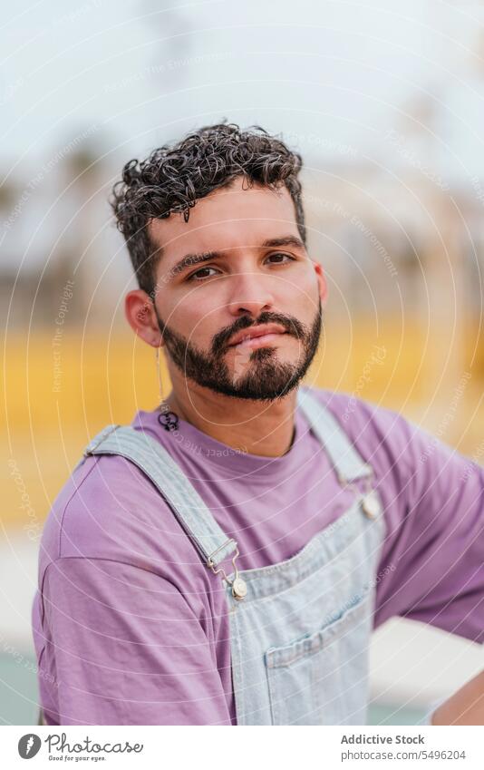 Serious young bearded man looking at camera pensive thoughtful serious sit unshaven alone headshot concentrate outfit focus serene unemotional think ponder