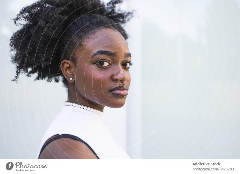 Unemotional black teenage girl in white dress teenager hairstyle hairdo happy portrait slim young female african american lady casual confident appearance calm