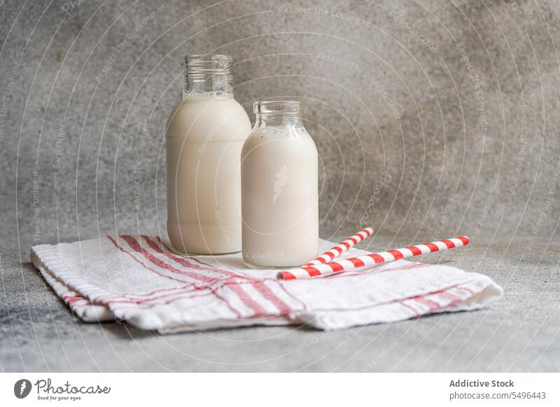 https://www.photocase.com/photos/5496443-raw-cow-milk-in-vintage-bottles-on-rustic-napkin-and-drinking-straws-photocase-stock-photo-large.jpeg