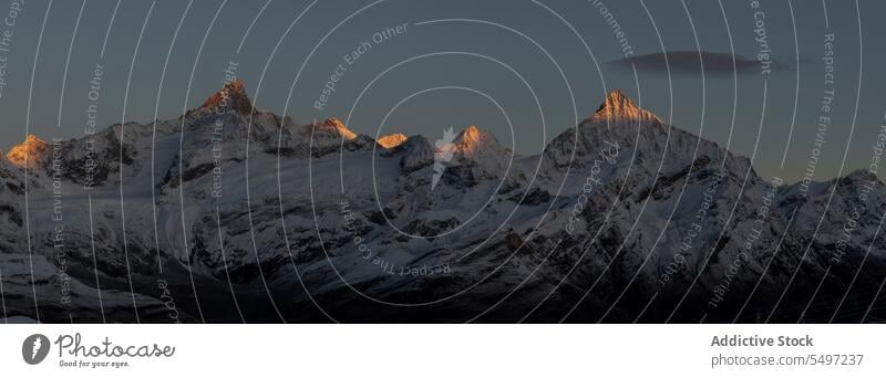 Snowy mountains in winter day under dark sky at sunrise landscape snow nature rocky peak picturesque ridge cold calm scenic range highland scenery north