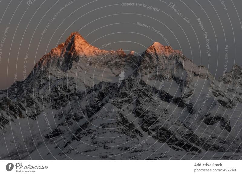 Snowy mountains in winter day under dark sky at sunrise landscape snow nature rocky peak picturesque ridge cold calm scenic range highland scenery north