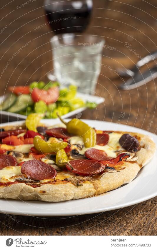 Pizza with salami and pepperoni Salami Chili Plate Close-up Meal Eating Mozzarella Cheese pizzeria Classic Orange menu photo Restaurant Italy Design concept