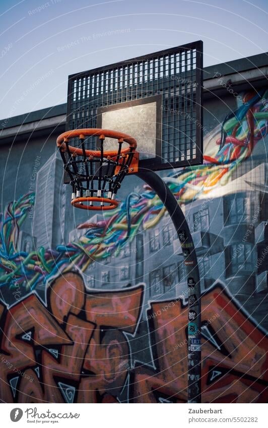 Basketball hoop in orange in front of wall with graffiti Basketball basket Graffiti Wall (building) urban Sports Athletic Playing Ball sports Basketball arena