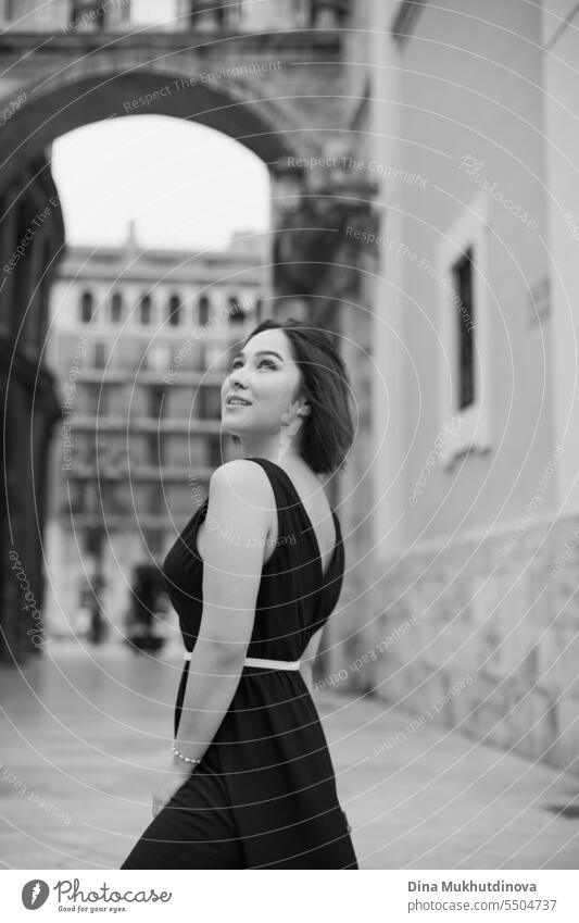 Fashion portrait of an young Indian Bengali brunette woman in black inner  wear and western jacket standing in front of a window in studio background.  Indian lifestyle and fashion photography. Stock Photo