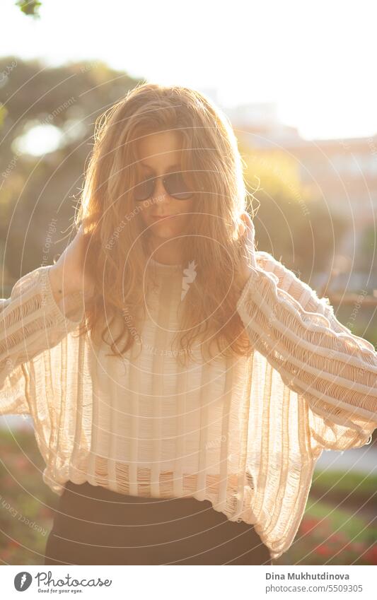 candid portrait of young beautiful woman in sunglasses. Pretty ginger girl with red hair. park smiling happy pretty Smiling cheerful attractive Woman Park