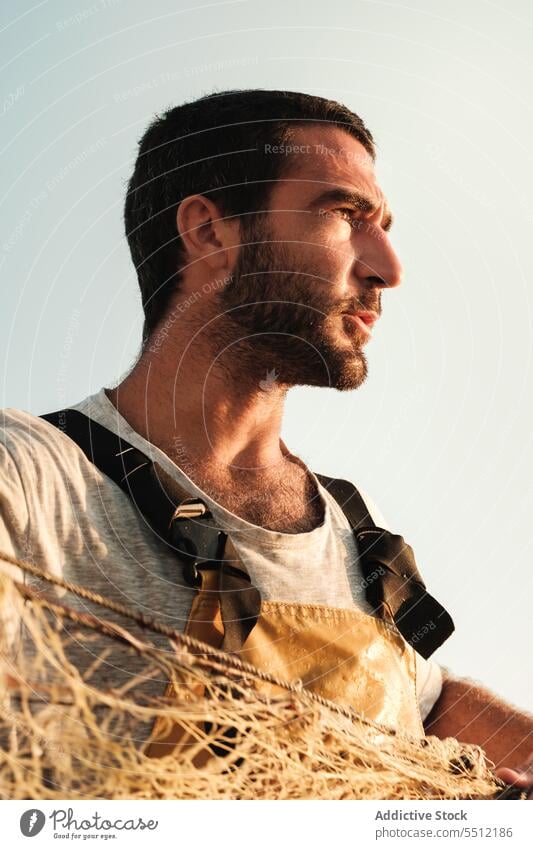 Contemplating fisherman with fishing net in sunset sailor tackle boat admire breathtaking male soller balearic islands mallorca seaman tradition seine fish hunt