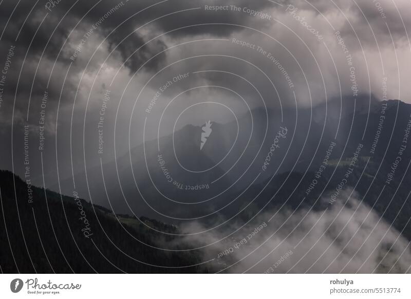 dramatic storm clouds over mountains in summer Alps alpine cloudscape sky shower thunderstorm fog mist view weather wind scenic scenery landscape nature