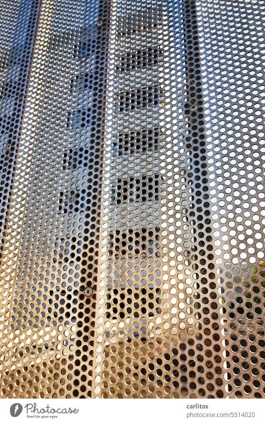 Sifted light | skyscraper behind perforated plate Fence Tin Plate with holes Screening High-rise Silver Hollow Round Metal Structures and shapes Detail Abstract