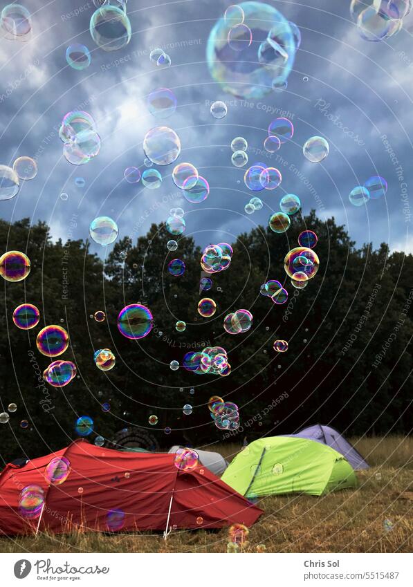 Soap bubbles fly over tents at forest edge in dramatic sky soap bubbles camping Tents festival Festivals Moody Hover Blow atmospheric outdoor Party Event