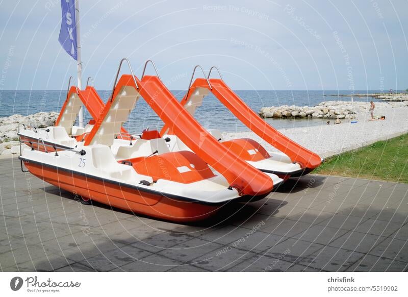 Pedal boat with slide stands on beach promenade Pedalo bank Promenade Water vacation holidays Driving Tourism Watercraft Boating trip Trip Vacation & Travel