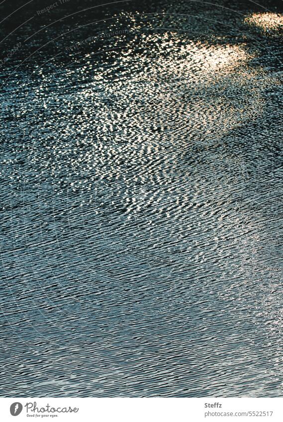 Sunlight reflected in water reflection Light mirrored Light reflection Water reflection light reflexes Distorted Waves Undulating Surface of water Abstract
