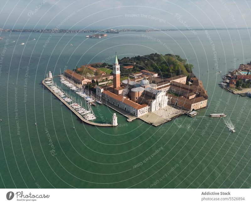 Drone view of sea island boats and church with tower travel vacation summer architecture cloudy seascape building blue shore city scenic trip coast water