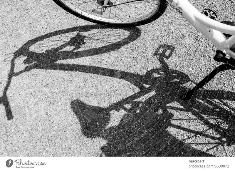 Shadow of a bicycle in the sun in detail Shadow image Bicycle Silhouette black-and-white black and white Saddle Steering wheel Handlebars Detail Close-up Pedals