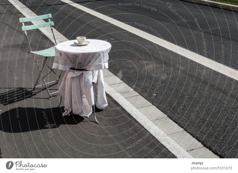 street cafe Sidewalk café Street Chair Table husk Coffee cup To have a coffee Café Gastronomy Empty Traffic lane Whimsical