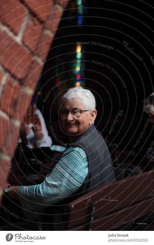 Wide land | Here we are cute smilingly Woman Sit Table Brick Town Bremen Vest Eyeglasses take a break Break Visual spectacle variegated