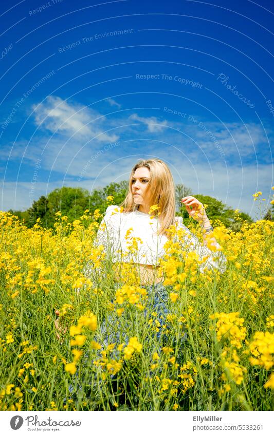 Young blonde woman in canola field Woman youthful Blonde Canola Canola field Freedom portrait Yellow Field Nature Summer Spring Blossoming Plant Environment