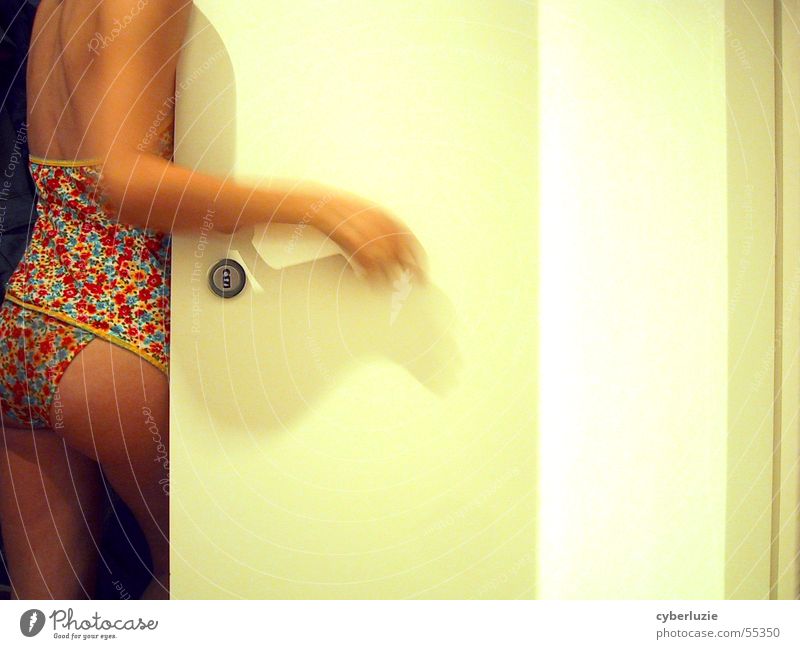 Seductive young topless brunette woman in blue panties, standing against  light background, covers her breast with elbows and looking at camera - a  Royalty Free Stock Photo from Photocase