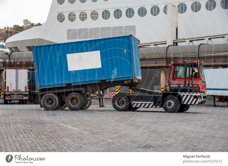 Specific truck for unloading ferry trailers, equipped with a lifting fifth wheel and automatic release, transporting a container. harbor logistic commerce