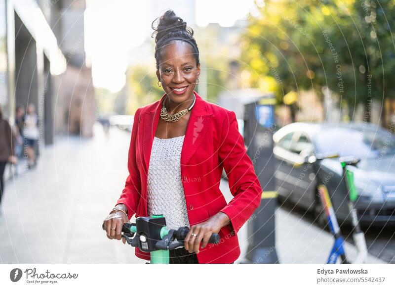 Portrait of a businesswoman with electric scooter in the city people downtown joy urban black natural attractive black woman happiness street happy modern