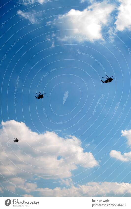 Three attack helicopters go to war and the sun laughs in the blue sky combat helicopter Aviation Helicopter Blackhawk War Aircraft three Flum machines Sky Blue