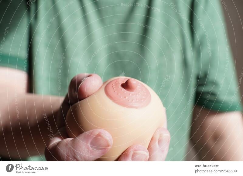 hand squeezing or groping boob shaped anti-stress ball - a Royalty Free  Stock Photo from Photocase