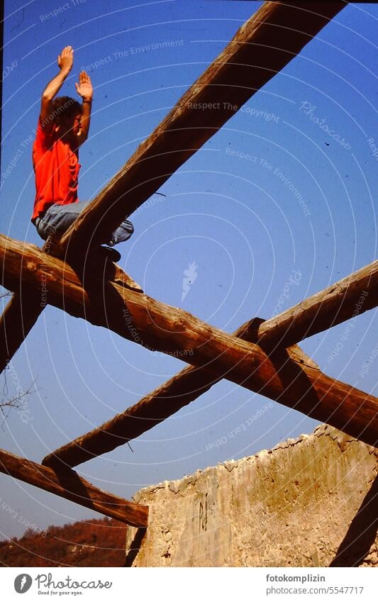 Man on a roof beam stretches his arms to the sky Human being Sky Roof beams Scaffolding Joist Armour Tall Yoga pray upright balance Balance conscious Free