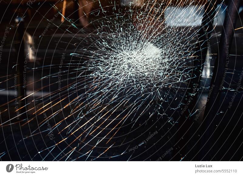 Shards in the glass of a store door, darkness and remains of street light jumps cracks shards Smashed window Vandalism Window pane Transience Destruction Force