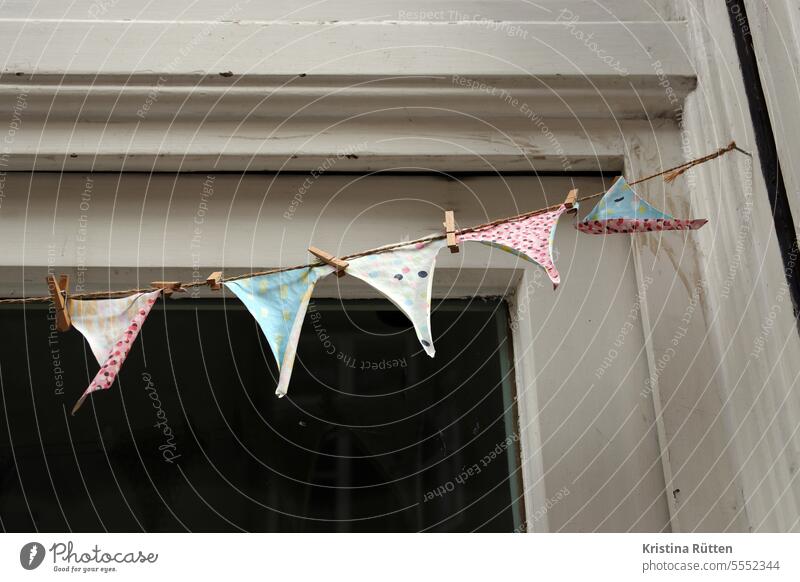 slightly weathered paper pennant pennant chain Paper Clothes peg wooden staples flag Paper chain Spotted eyeballed Weathered faded crimped Torn String leash