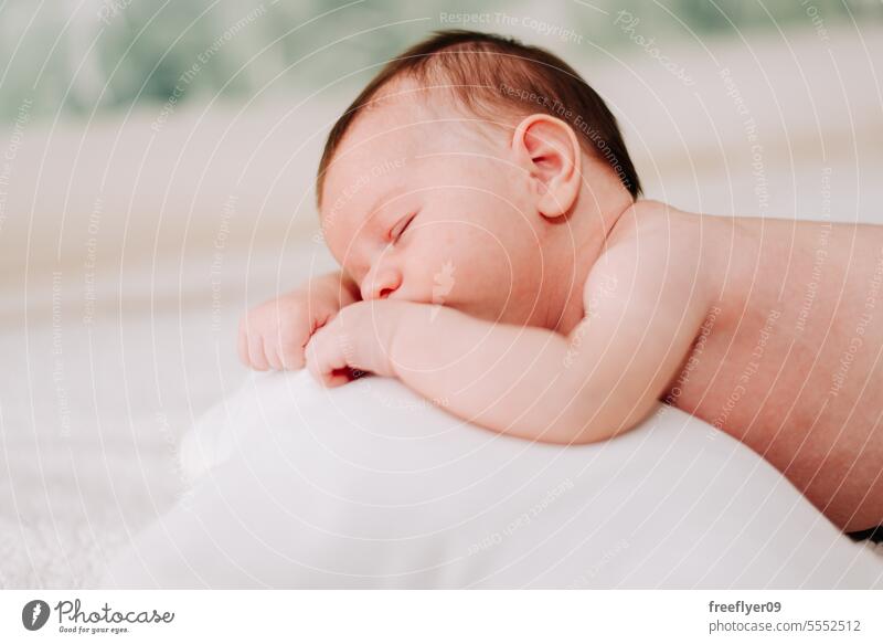 portrait of a newborn asleep in studio lighting baby firstborn laying laying down copy space parenthood motherhood innocence life labor young boy happy small
