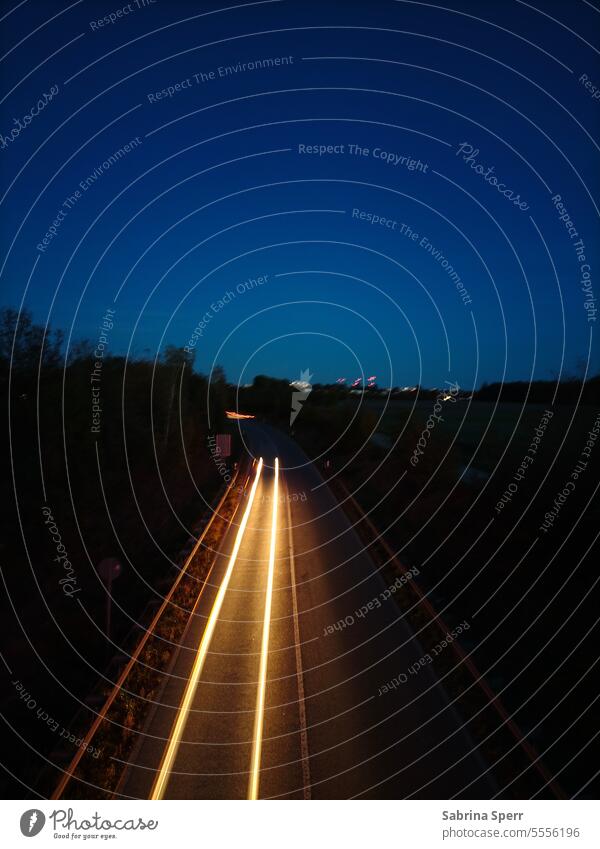 Long exposure of a passing car at night Highway Night Dark Blue Contrast Black Light Bright pretence Floodlight Lamp Beam of light Cloudless sky Street