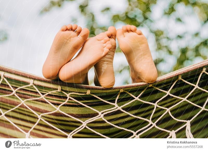 Feet of children, which swinging on hammock at summer.Kids relax,happy childhood authentic beautiful carefree caucasian comfortable daytime desk enjoy enjoyment