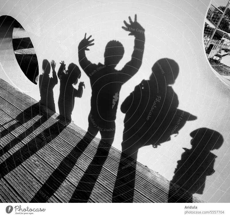 Shadow family photo b/w Wall (building) persons people Family Arm Body pose group Adults children Shadow play shadow cast Contrast Silhouette Light and shadow