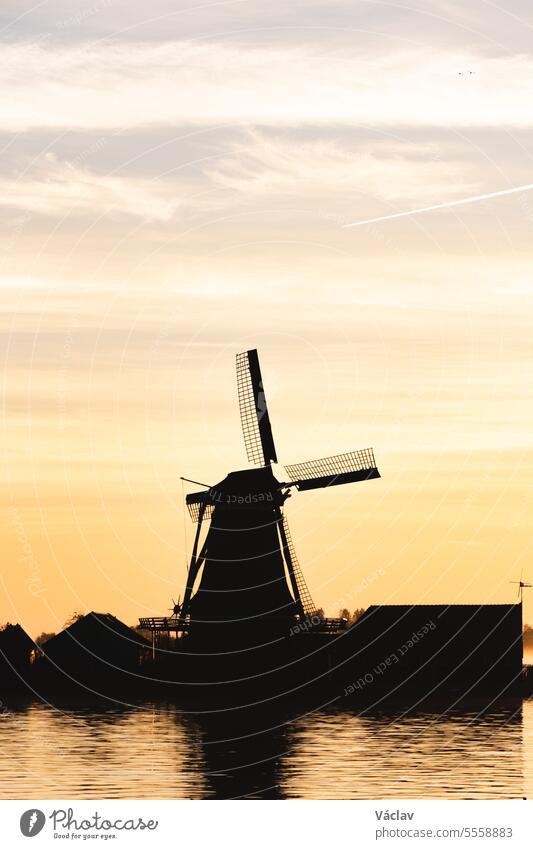 Popular tourist spot Zaanse Schans is near Amsterdam in the west of the Netherlands. Historical, realistic windmills during sunrise. Holland's landmark