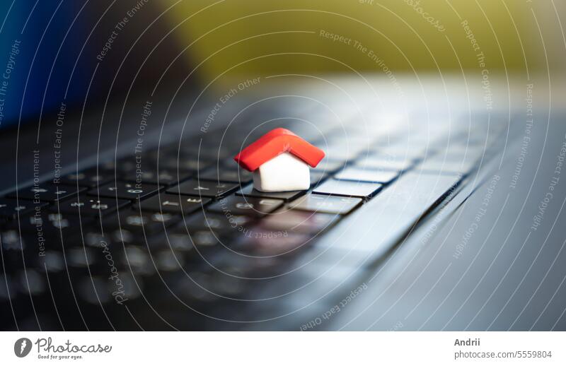 House on a computer keyboard. Paying bills online. House and utilities. Electricity, heating, water and gas. Energy efficiency. Electronic documentation in registers. Registration of property.