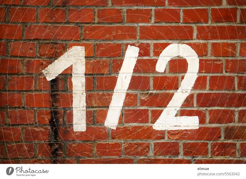 1 / 2 stands in white on a red brick wall figures cut in half 1/2 one and a half Numbers Half Digits and numbers Mathematics Wall tile Blog Calculation