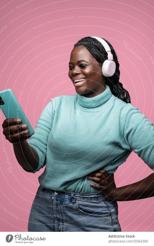 African woman enjoying music with smartphone a Royalty Free