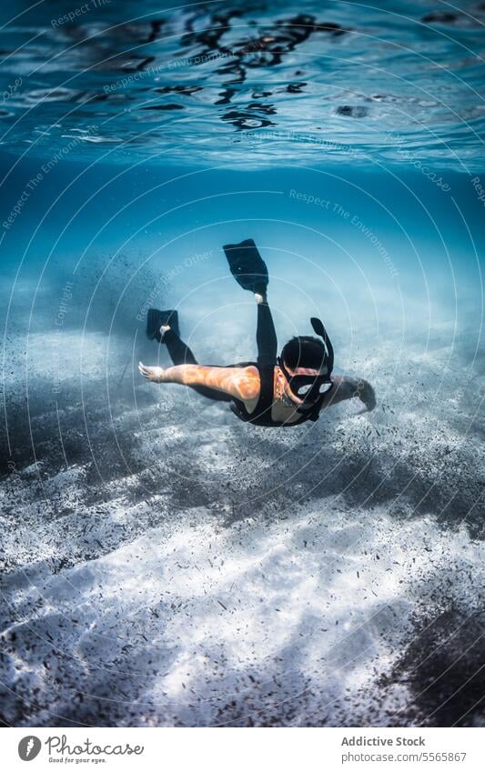 A man swimming in the ocean with a mask on snorkel underwater Menorca Mediterranean Sea beach clear water marine life fish diving snorkeling adventure