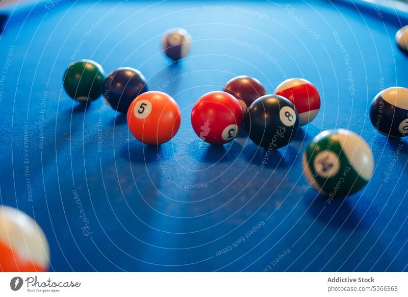 Colorful billiard balls on blue pool table leisure recreational pub play indoors game sport snooker colorful different number bar hobby entertainment set object