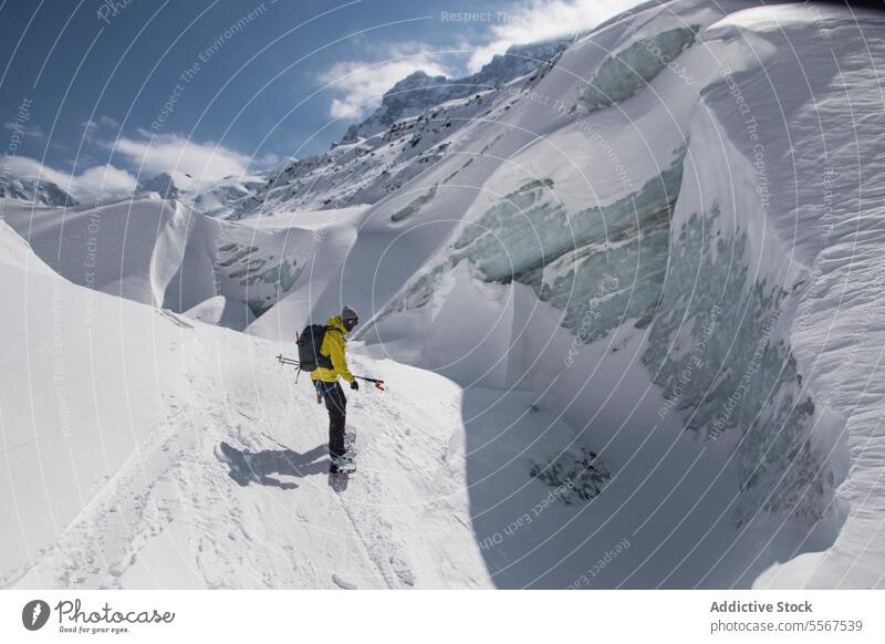 Person hiking on snow mountain during vacation person anonymous walking covering unrecognizable pole travel peak adventure together side view land challenge