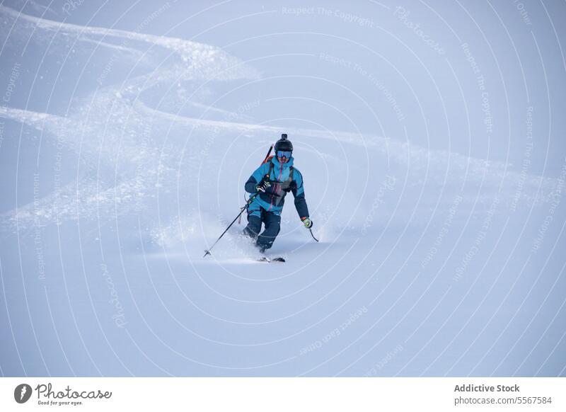 Anonymous person descending snowcapped mountain skier unrecognizable pole covering skiing effort challenge vacation active adventure swiss alps range hiking