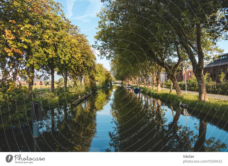 Transportation between cities using a water canal to complement the country's infra-structure. Dutch transport between cities. Shipping waterfront no people