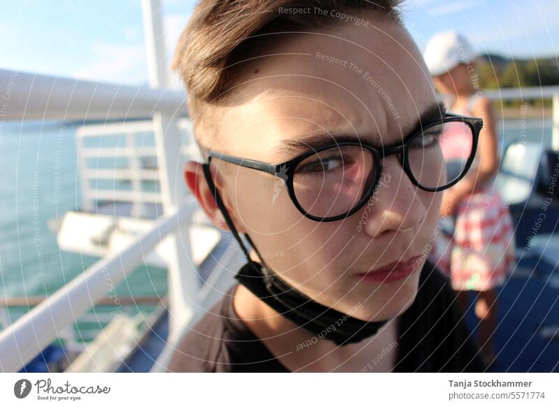 Teenager with a furrowed brow teenager Young man boy wrinkle portrait Person wearing glasses Vacation photo Navigation vacation critical view short hair