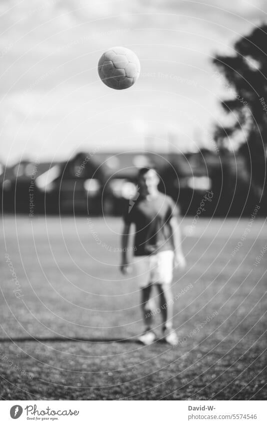 Playing soccer - soccer player with ball Foot ball Soccer player EM UEFA European Championship hobby Black & white photo Nostalgia Past Ball Flying Sports