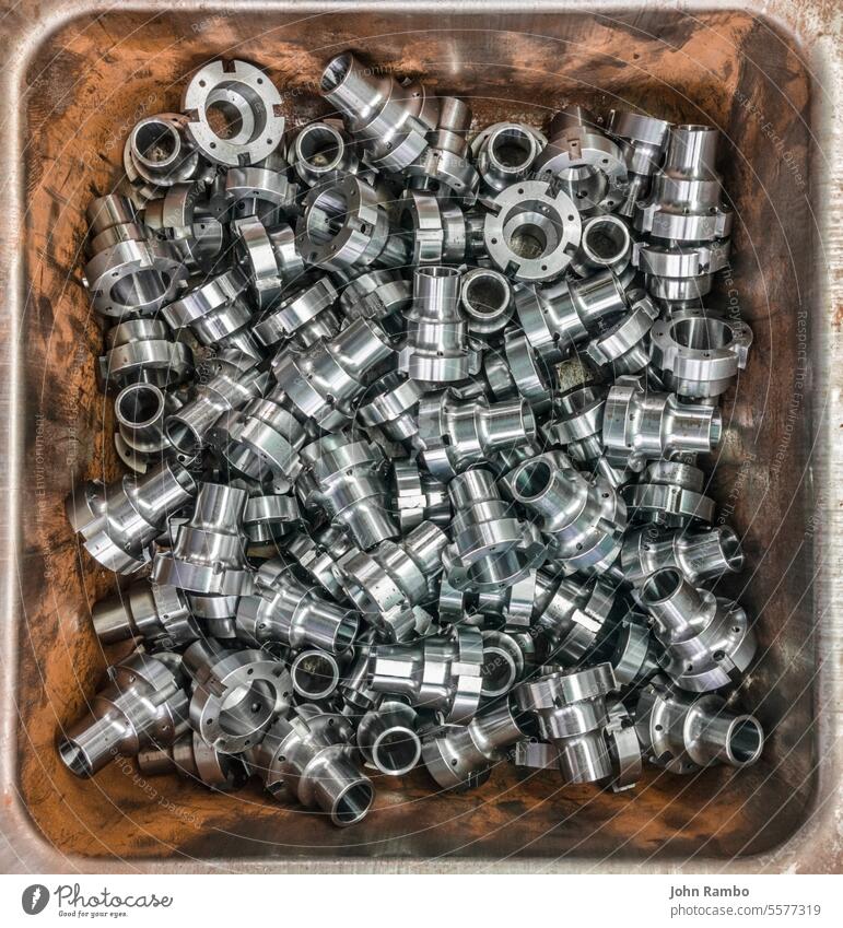Shiny steel parts in rusted iron box factory metal accuracy shiny many chaotic background chrome industry cylindrical production engineering hardware technology