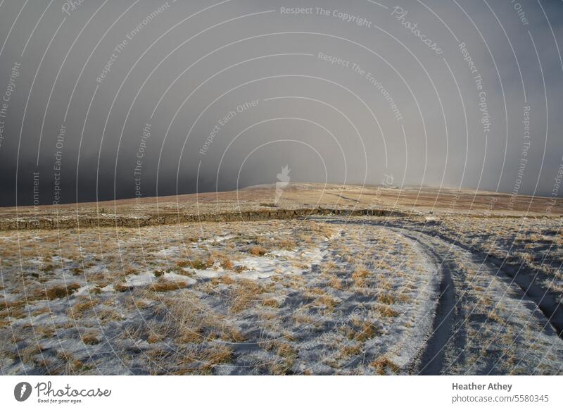 Snow shower approaching on a moorland track in Cumbria, UK Storm Storm clouds Weather Winter Hill Moor England Tracks Exterior shot Nature Landscape Clouds